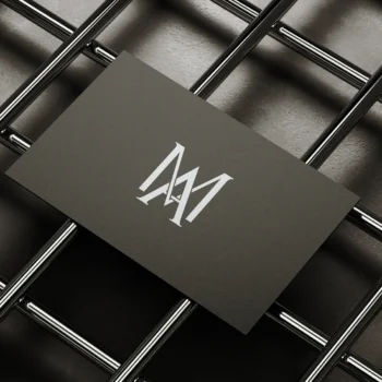 Minimalistic business card featuring a stylish AM monogram in black and white.